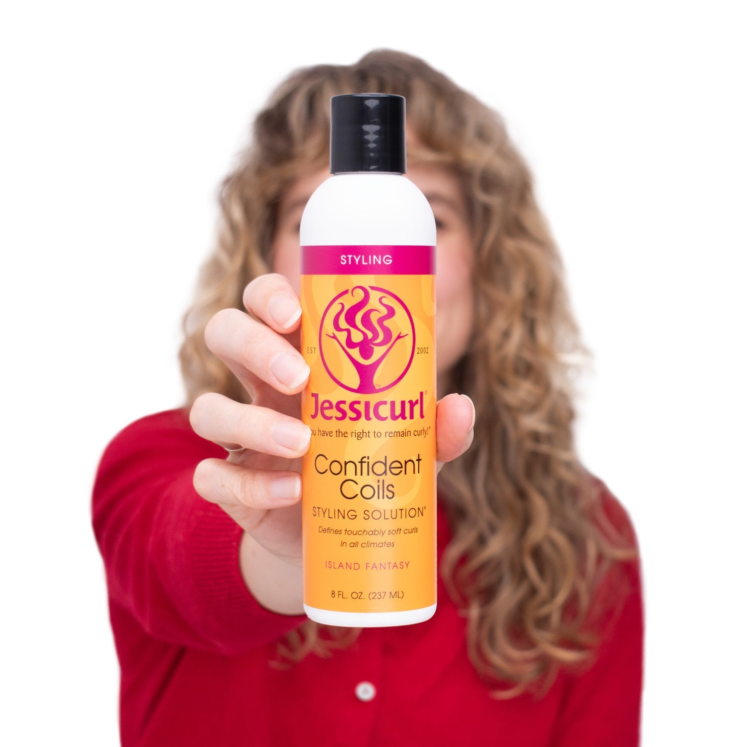 Person holding a bottle of Jessicurl Confident Coils Styling Solution with a white background